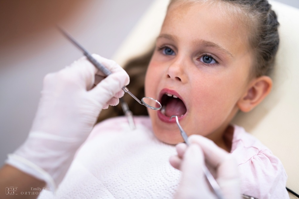 a little girl having her mouth examined as one of the procedures of how to fix overbite in Chester Springs, pa