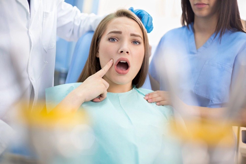 girl in dental ambulance show sore spot - how to fix overbite in Chester Springs, PA